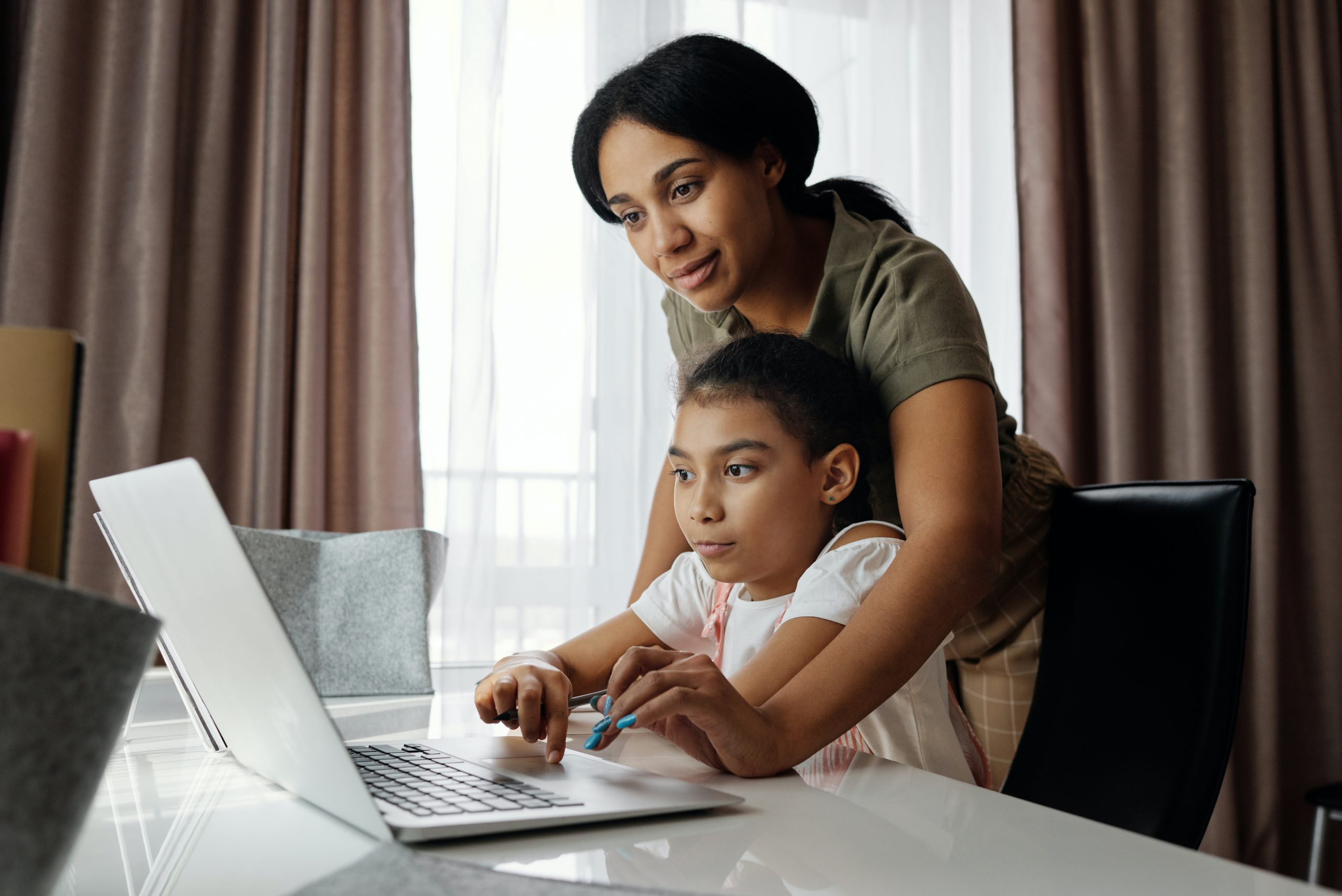 woman and daughter use computer