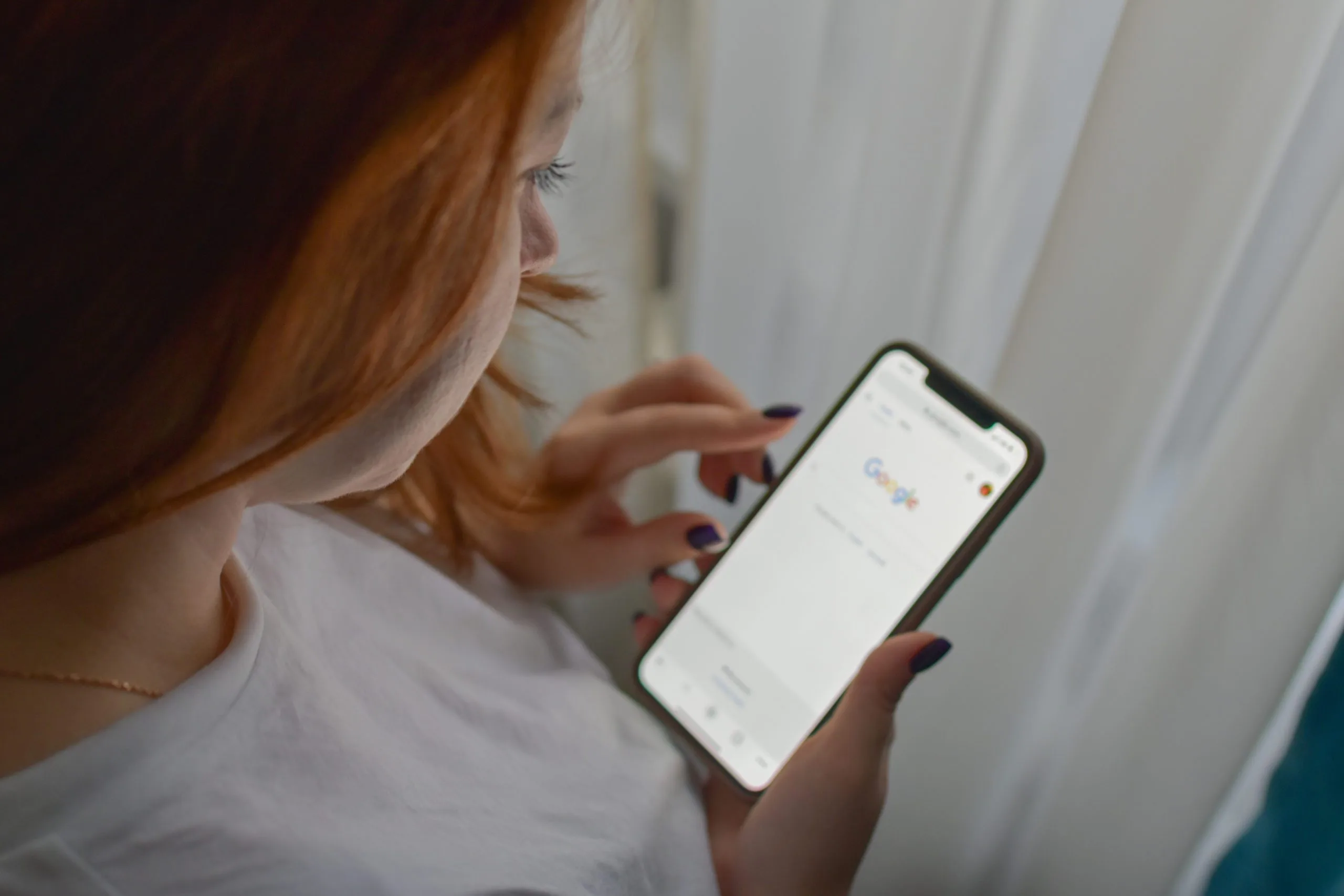 Woman using mobile for online searches in google