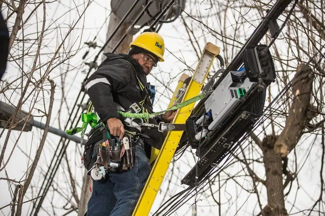 bell canada technician installing new fibre to home customer's line