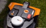 Worx Landroid Vision Cloud robotic lawn mower control panel with a red stop button and white RTK antenna
