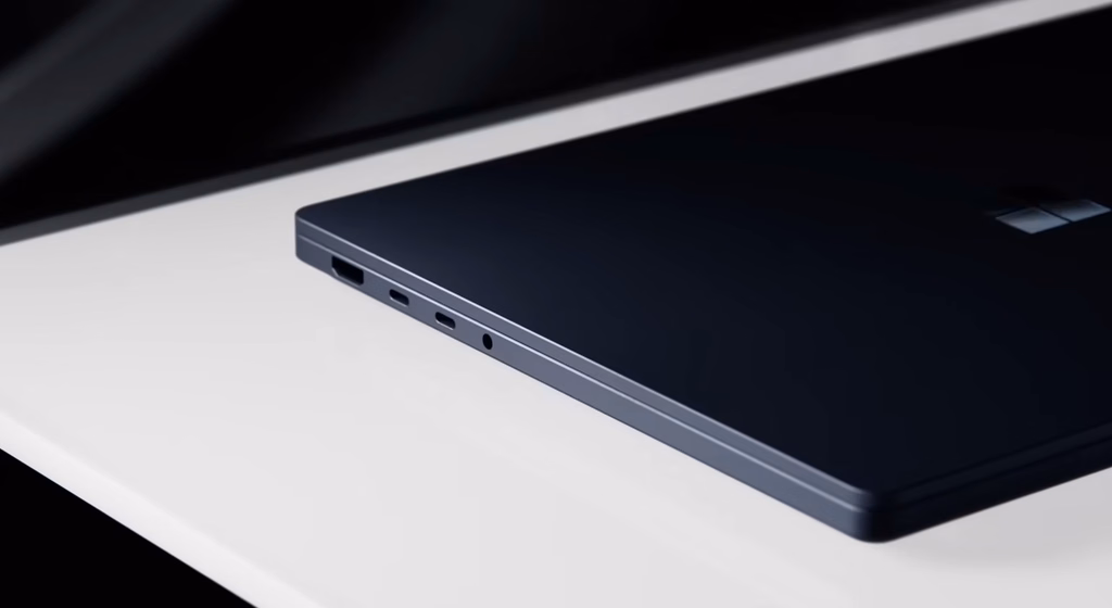 Side view of a dark laptop showing its USB-A port, two USB-C ports, and a headphone jack